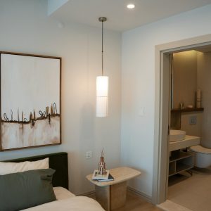 Luxurious minimalist bedroom with modern decor and attached bathroom.